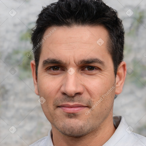 Joyful white adult male with short  black hair and brown eyes