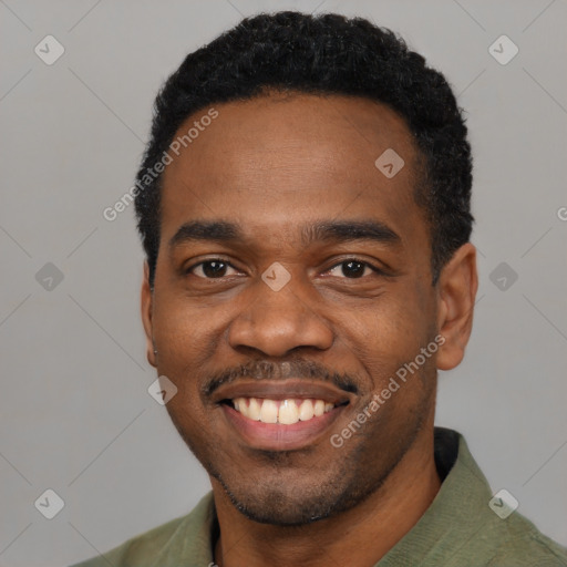 Joyful black young-adult male with short  black hair and brown eyes