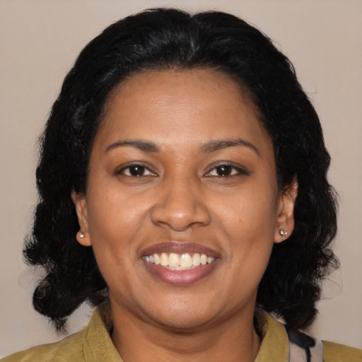 Joyful black adult female with medium  black hair and brown eyes