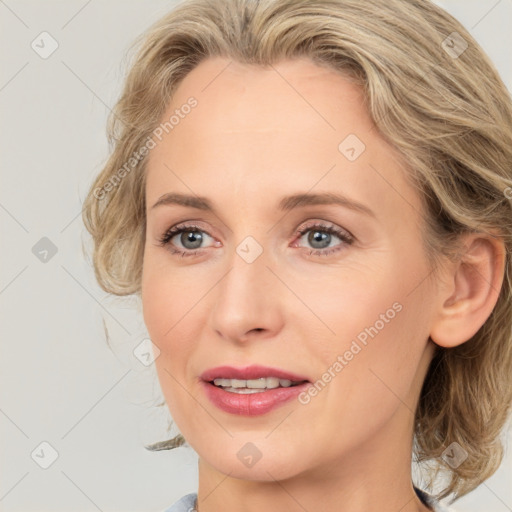 Joyful white young-adult female with medium  brown hair and blue eyes