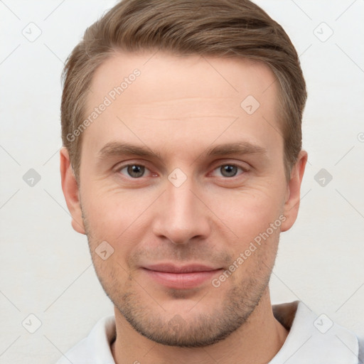 Joyful white young-adult male with short  brown hair and grey eyes