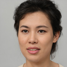 Joyful asian young-adult female with medium  brown hair and brown eyes