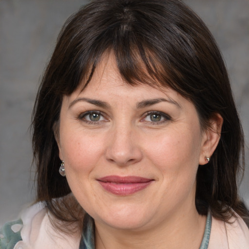 Joyful white adult female with medium  brown hair and brown eyes