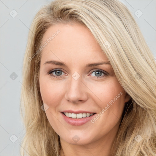 Joyful white young-adult female with long  brown hair and blue eyes