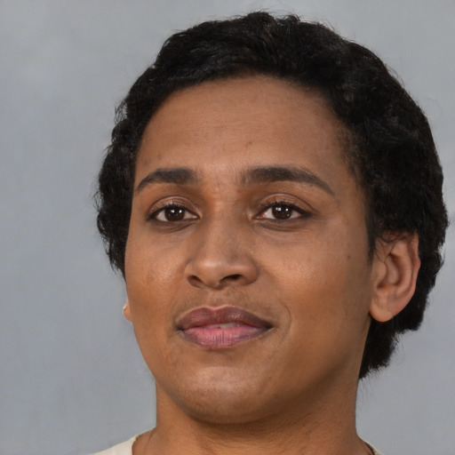 Joyful black adult female with short  black hair and brown eyes