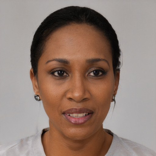 Joyful black young-adult female with short  black hair and brown eyes