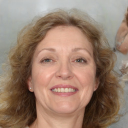 Joyful white adult female with medium  brown hair and blue eyes