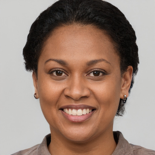 Joyful latino adult female with short  brown hair and brown eyes