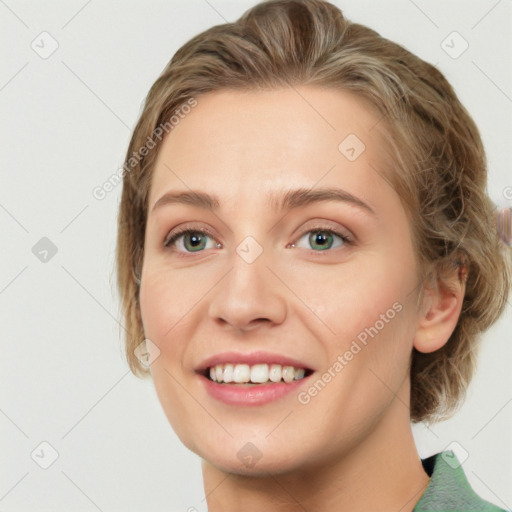 Joyful white young-adult female with medium  brown hair and green eyes