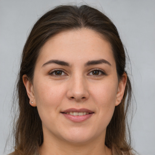 Joyful white young-adult female with medium  brown hair and brown eyes