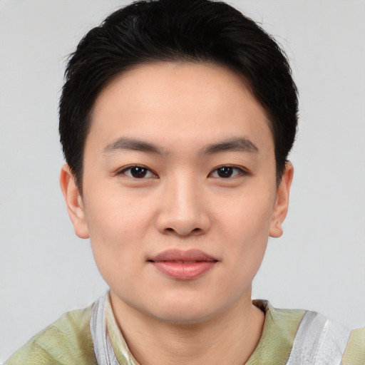 Joyful asian young-adult male with short  brown hair and brown eyes