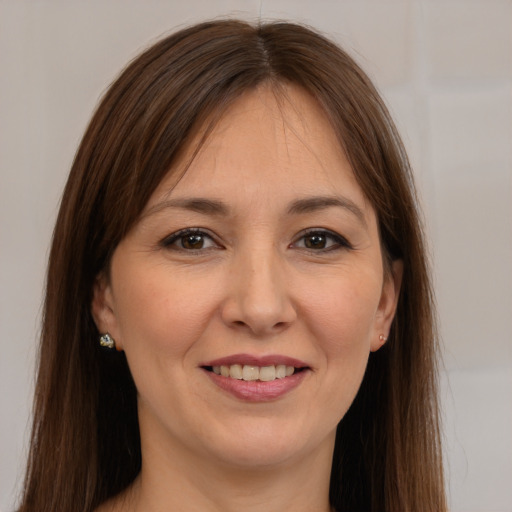 Joyful white young-adult female with long  brown hair and brown eyes