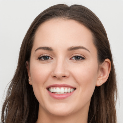 Joyful white young-adult female with long  brown hair and grey eyes