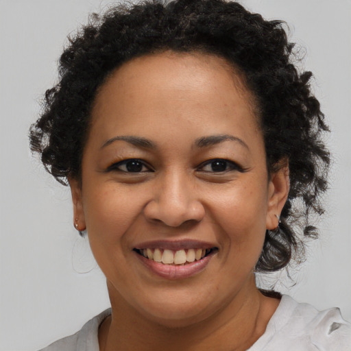Joyful black young-adult female with medium  brown hair and brown eyes