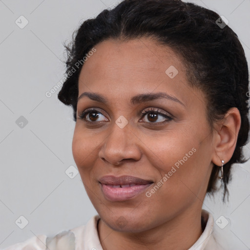 Joyful black young-adult female with short  brown hair and brown eyes