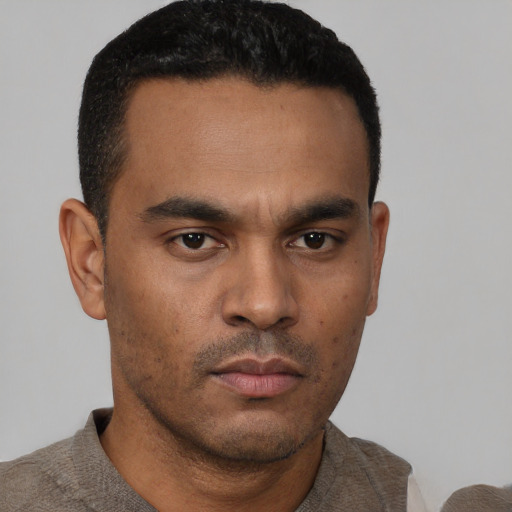Neutral latino young-adult male with short  black hair and brown eyes