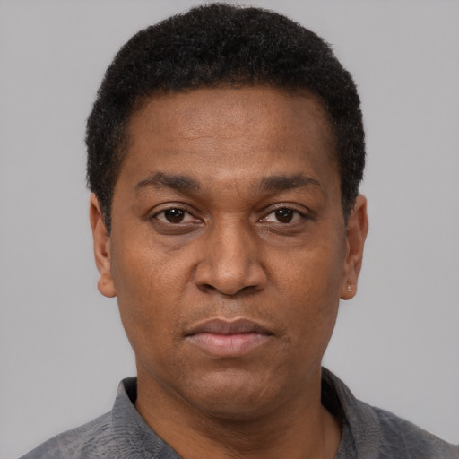 Neutral latino adult male with short  black hair and brown eyes