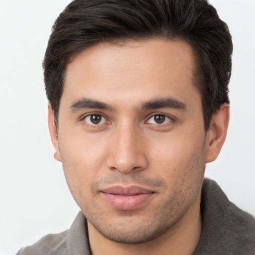 Joyful white young-adult male with short  brown hair and brown eyes