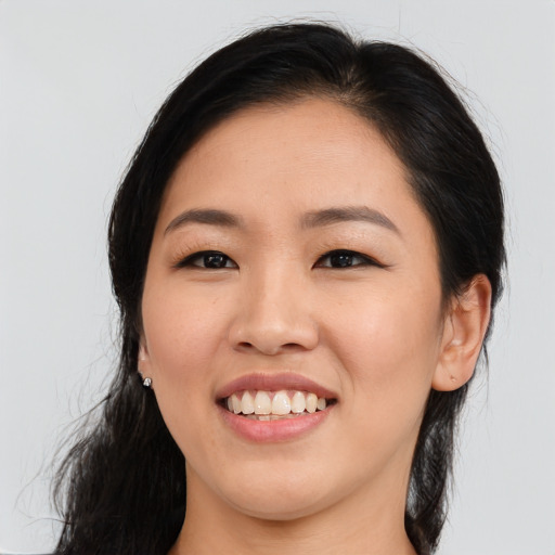 Joyful asian young-adult female with long  brown hair and brown eyes