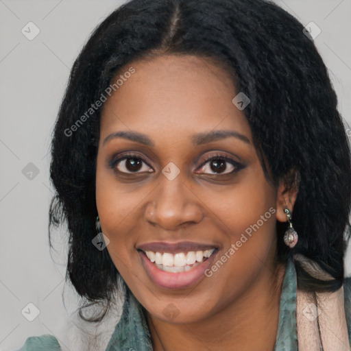 Joyful black young-adult female with long  black hair and brown eyes