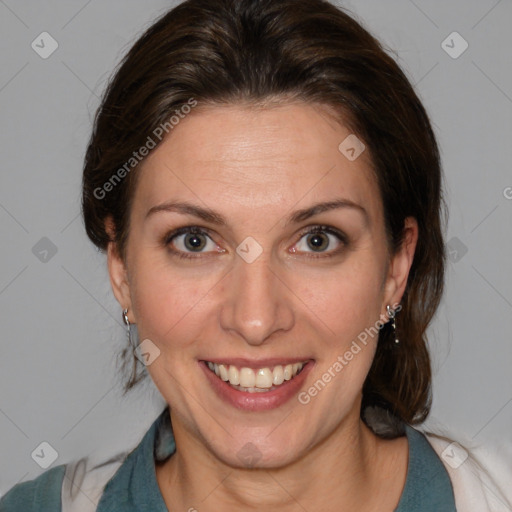 Joyful white adult female with medium  brown hair and blue eyes