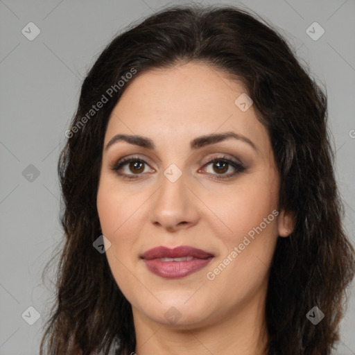 Joyful white adult female with long  brown hair and brown eyes