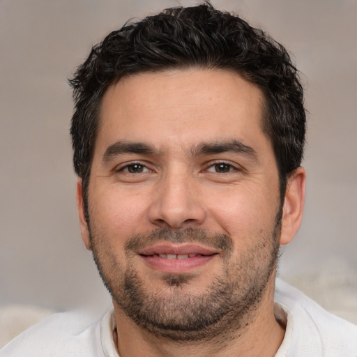 Joyful white young-adult male with short  black hair and brown eyes