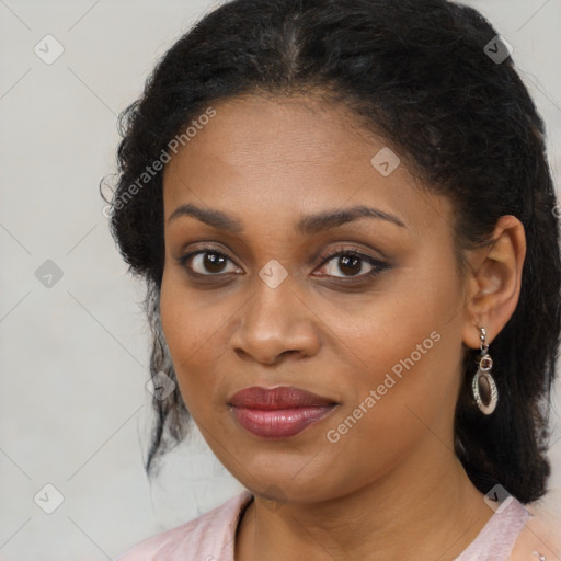 Joyful black young-adult female with long  brown hair and brown eyes