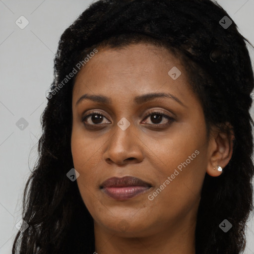 Joyful black young-adult female with long  brown hair and brown eyes