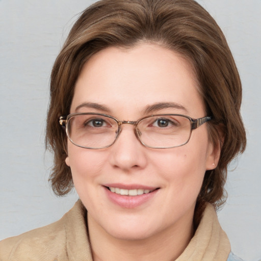 Joyful white young-adult female with medium  brown hair and blue eyes