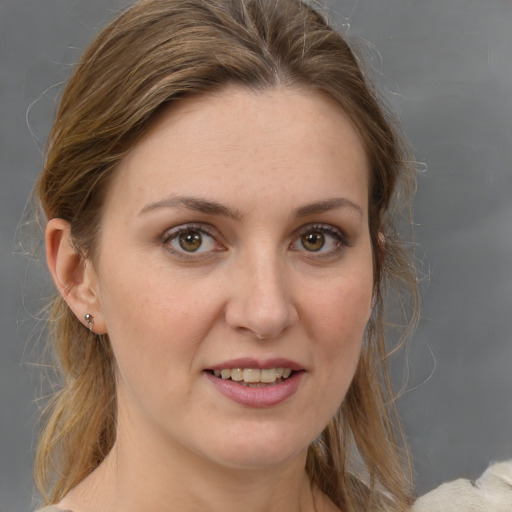 Joyful white young-adult female with medium  brown hair and grey eyes