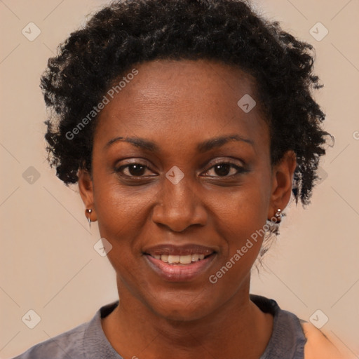 Joyful black adult female with short  black hair and brown eyes