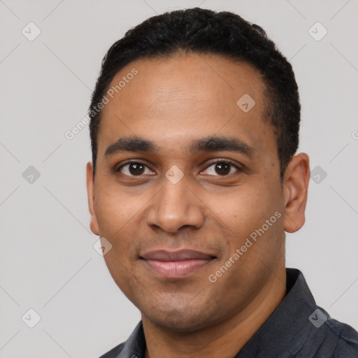 Joyful black young-adult male with short  black hair and brown eyes