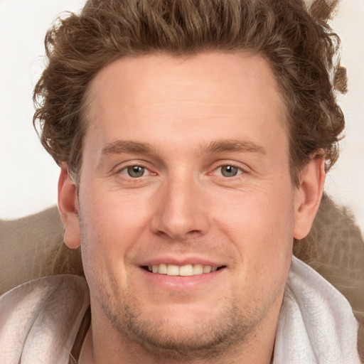 Joyful white adult male with short  brown hair and grey eyes