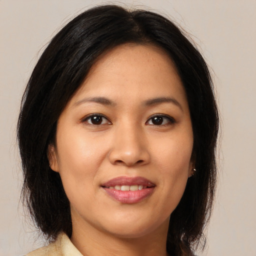Joyful asian young-adult female with long  brown hair and brown eyes