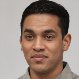 Joyful latino young-adult male with short  black hair and brown eyes