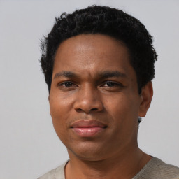 Joyful black adult male with short  black hair and brown eyes