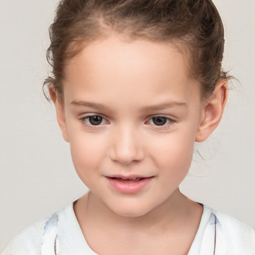 Joyful white child female with short  brown hair and brown eyes