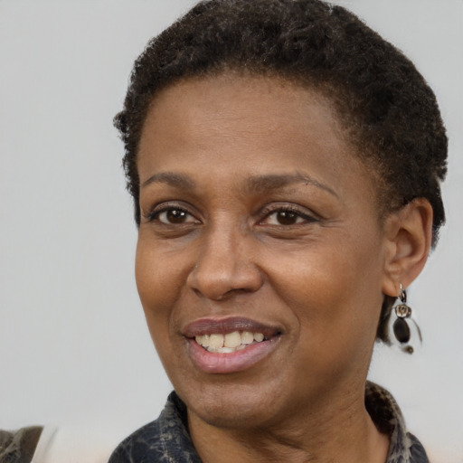 Joyful latino adult female with short  brown hair and brown eyes