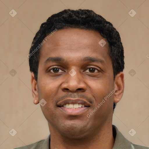 Joyful black young-adult male with short  black hair and brown eyes