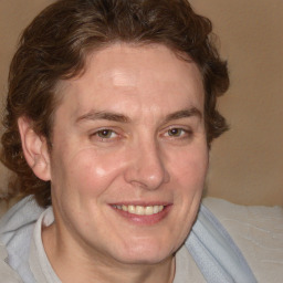 Joyful white adult male with medium  brown hair and brown eyes