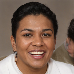 Joyful latino young-adult female with short  brown hair and brown eyes
