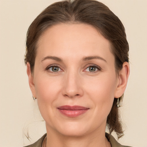 Joyful white adult female with medium  brown hair and grey eyes