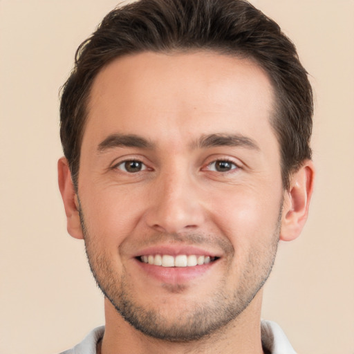 Joyful white young-adult male with short  brown hair and brown eyes