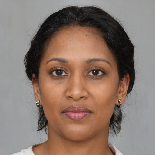 Joyful black young-adult female with medium  brown hair and brown eyes