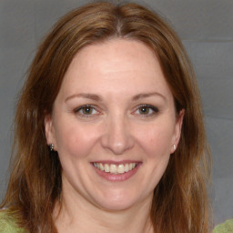 Joyful white adult female with medium  brown hair and brown eyes