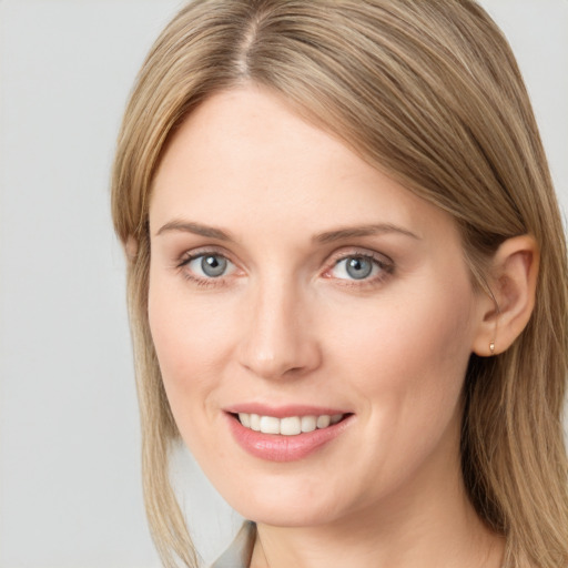 Joyful white young-adult female with long  brown hair and grey eyes