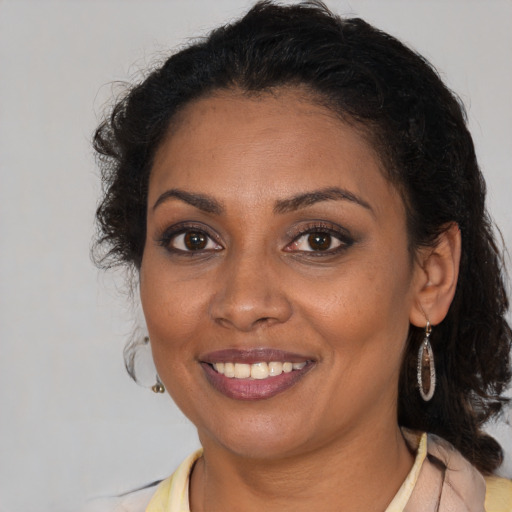 Joyful black young-adult female with medium  brown hair and brown eyes