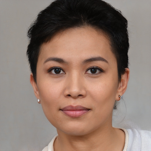 Joyful asian young-adult female with short  brown hair and brown eyes