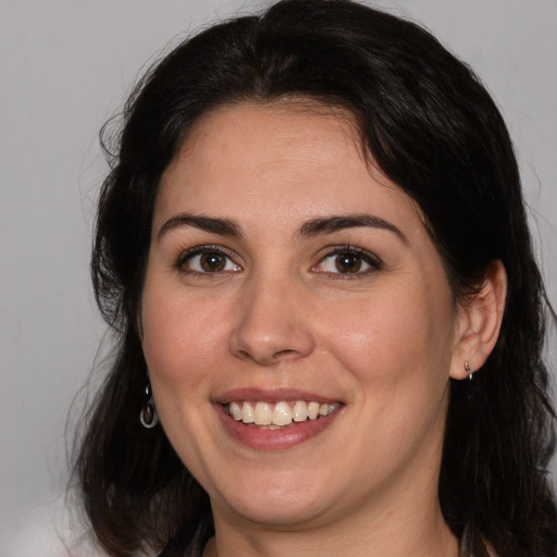 Joyful white adult female with medium  brown hair and brown eyes